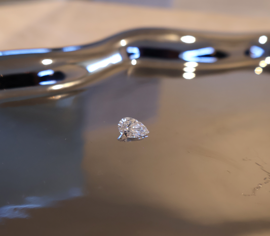 Pear-shaped diamond on a reflective surface